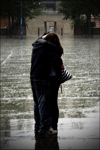 kissing in rain. couple kissing in the rain